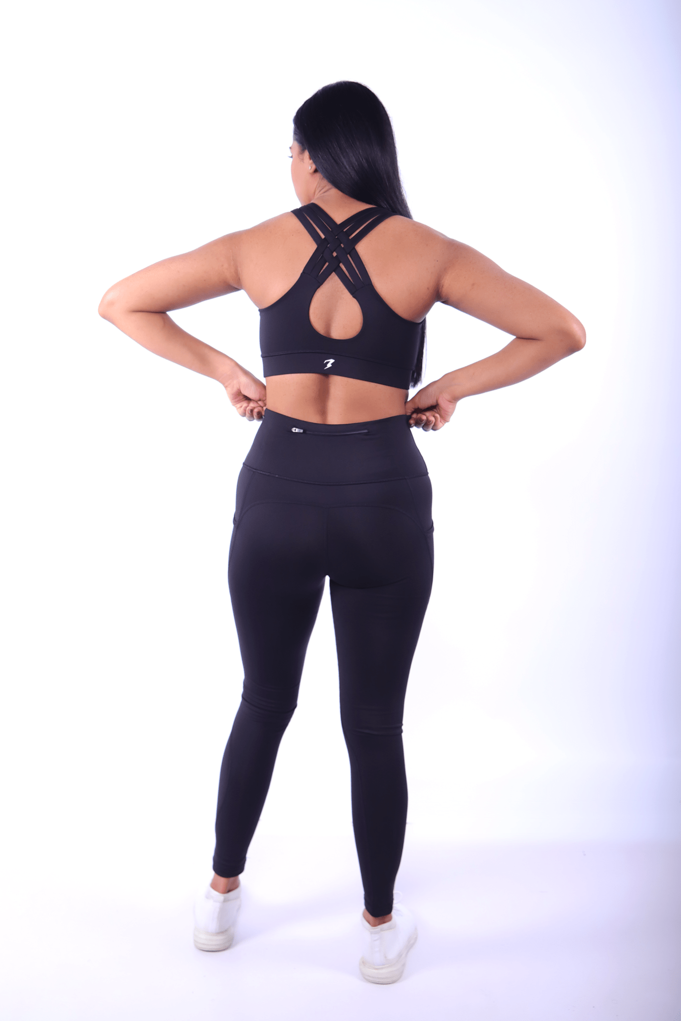 Back view of black gym set with racerback sports bra and sculpting leggings