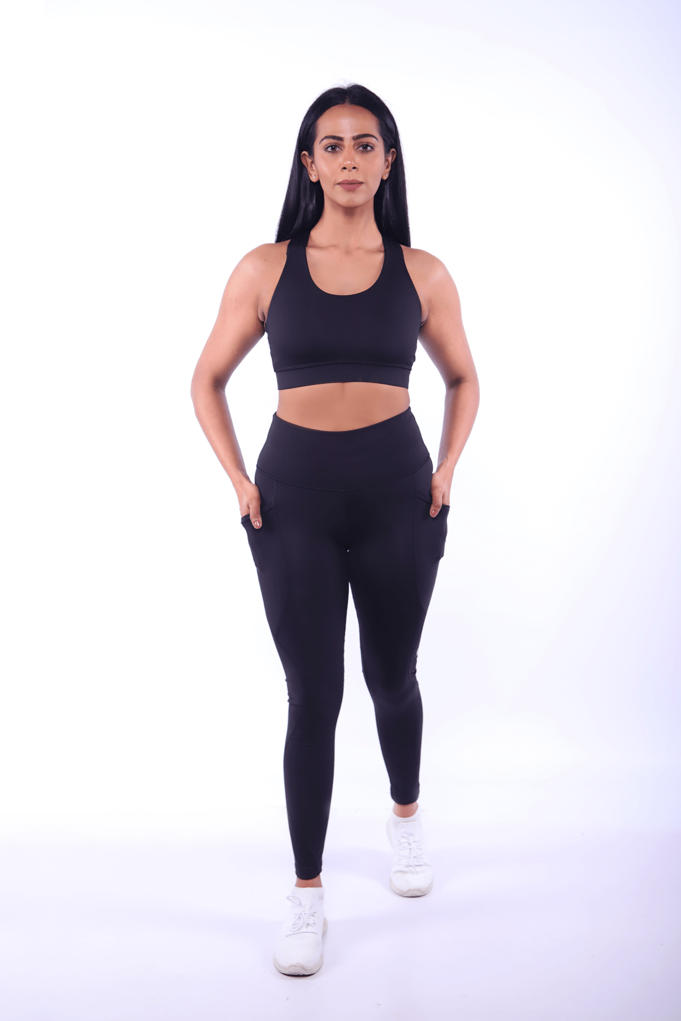 Black activewear set with supportive sports bra and high‑waist, squat‑proof leggings for women.