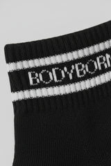 Black sock with white stripes and 'BODYBORN' branding on a light gray background with a premium feel, soft and comfortable