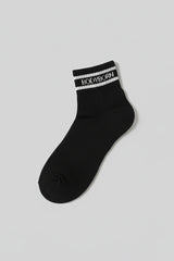 Black sock with 'BODYBORN' branding on a light gray background with a premium feel, soft and comfortable