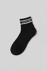 Black sock with 'BODYBORN' branding on a light gray background with a premium feel, soft and comfortable