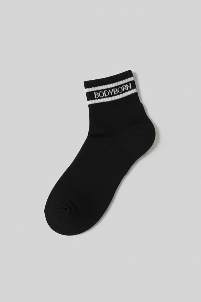 Black sock with 'BODYBORN' branding on a light gray background with a premium feel, soft and comfortable