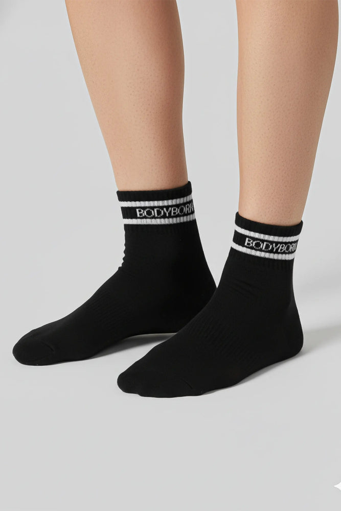 Black socks with 'BODYBOY' branding on a light gray background with a premium feel, soft and comfortable