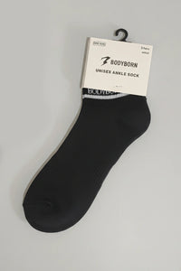 Black ankle sock with 'BODYBORN' packaging on a gray background with a premium feel, soft and comfortable