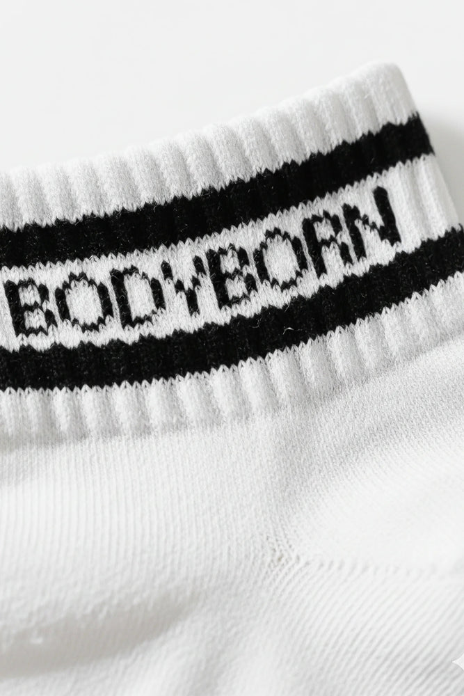 White sock with black band featuring 'BODYBORN' in ankle size