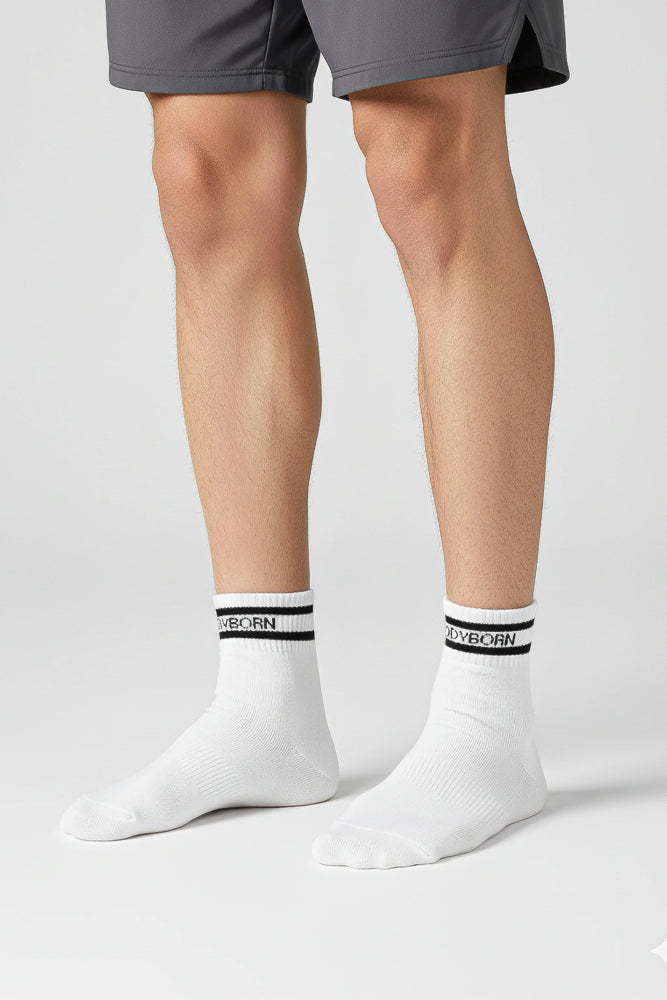 Bodyborn Glacier White socks with black bands worn by a person in ankle size