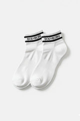 Bodyborn Glacier White socks with black bands worn by a person in ankle size