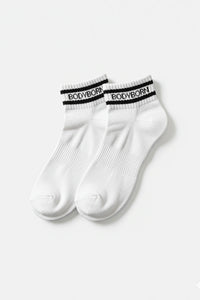 Bodyborn Glacier White socks with black bands worn by a person in ankle size