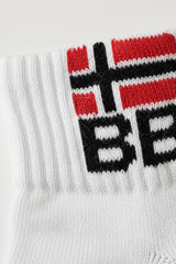 Bodyborn white sock with red, black, and white logo on a light gray background closeup material in ankle size