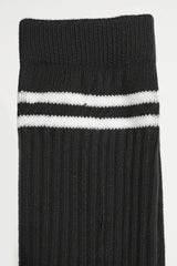 Black sock with two white stripes on a light gray background comfortable and soft