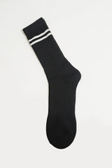 Black sock with white stripes on a light gray background in crew size soft and comfortable