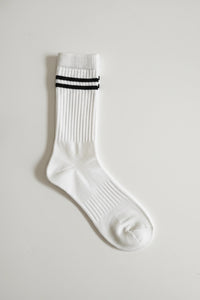 White sock with black stripes on a light gray background in crew size soft and comfortable
