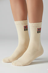 Beige socks with a bodyborn logo on a gray background in crew size premium soft and comfortable