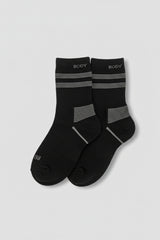 Pair of black socks with gray stripes on a light gray background  in crew size soft and comfortable