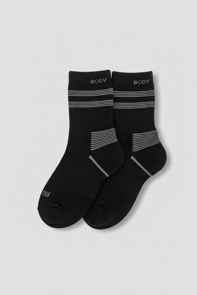 Pair of black socks with gray stripes on a light gray background  in crew size soft and comfortable