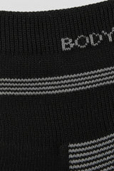 Close-up of black socks with white and gray stripes and 'BODYBORN' in crew size soft and comfortable