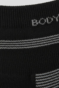 Close-up of black socks with white and gray stripes and 'BODYBORN' in crew size soft and comfortable