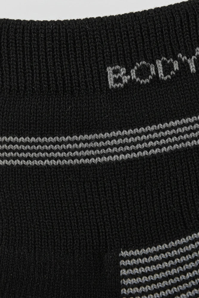 Close-up of black socks with white and gray stripes and 'BODYBORN' in crew size soft and comfortable
