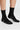 Black socks with bodyborn logo worn by a person on a light gray background in crew size soft and comfortable