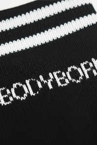 Black and white striped sock with 'BODYBORN' text in crew size comfortable and soft