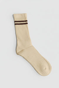 Beige sock with two brown stripes on a light gray background with a premium feel, soft and comfortable