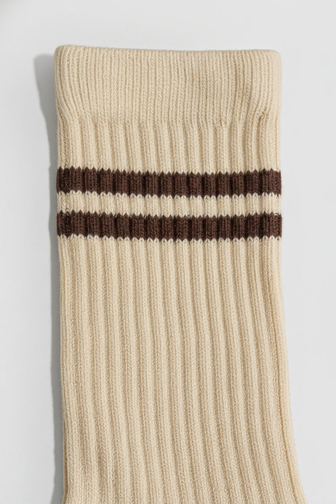 Beige sock with two brown stripes on a light gray background with a premium feel, soft and comfortable