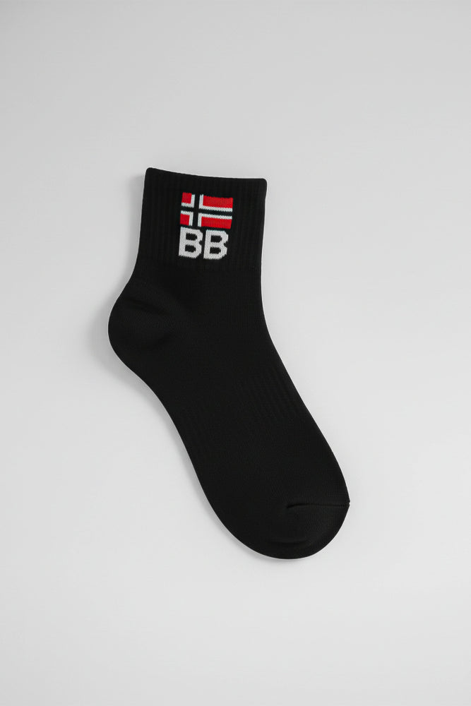 Black sock with a bodyborn logo on a light gray background in ankle size soft and comfortable