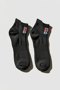 Pair of black socks with a Bodyborn logo on a light gray background in low cut size comfortable and soft