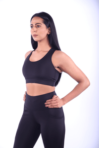  Side profile of black leggings with bum‑sculpting knit and phone pocket.