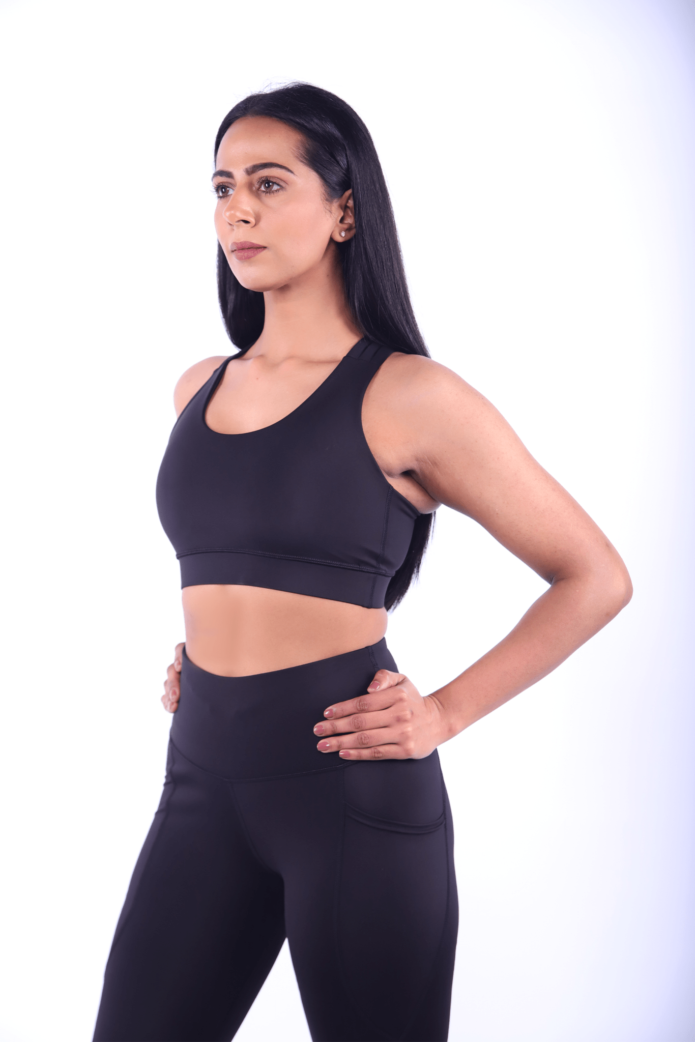  Side profile of black leggings with bum‑sculpting knit and phone pocket.