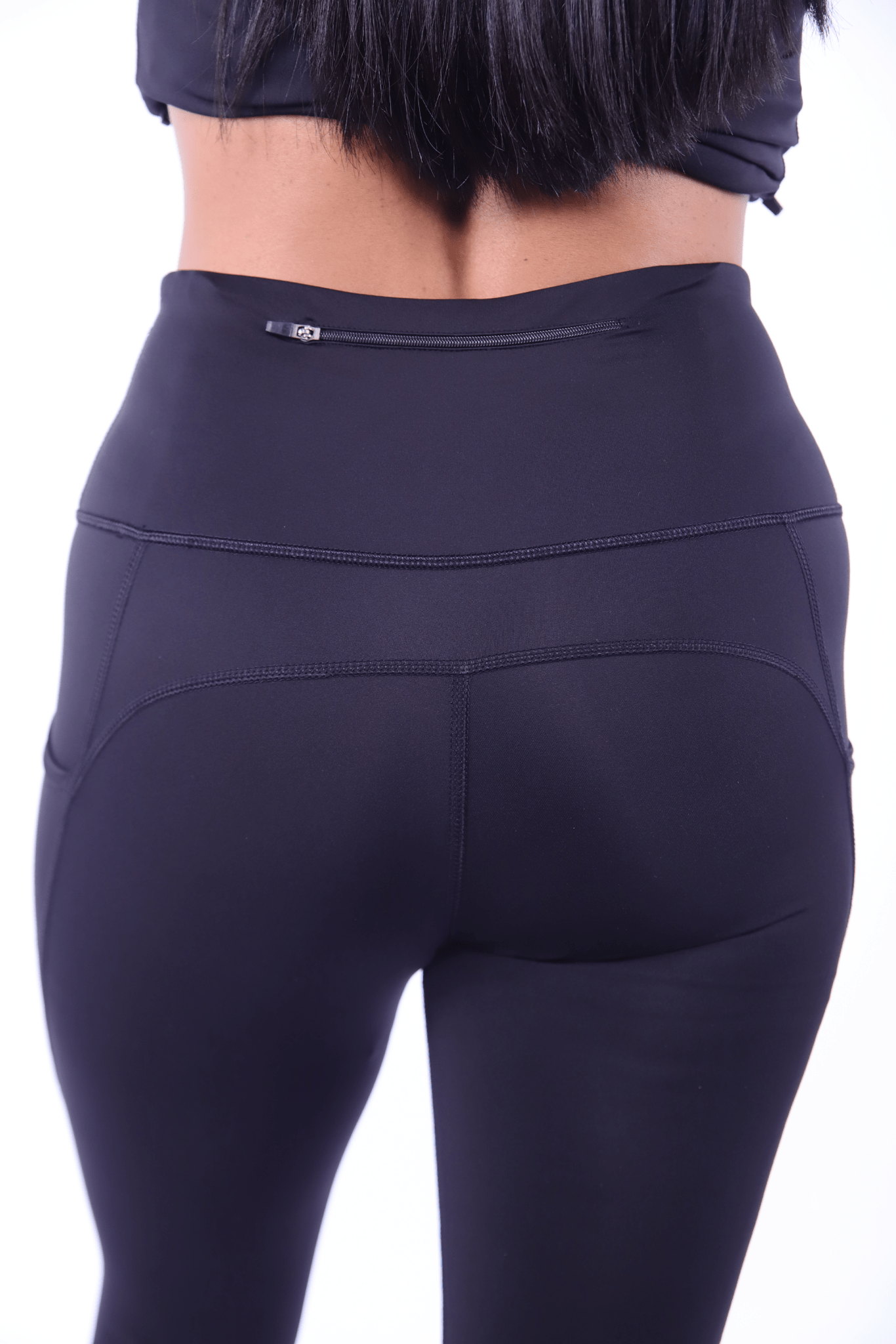Back waistband zip pocket keeps valuables safe without bounce.​

