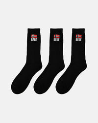 Three black crew-length socks arranged in a row on a white background, each featuring ribbed texture and embroidered BB branding with a red and white flag design
