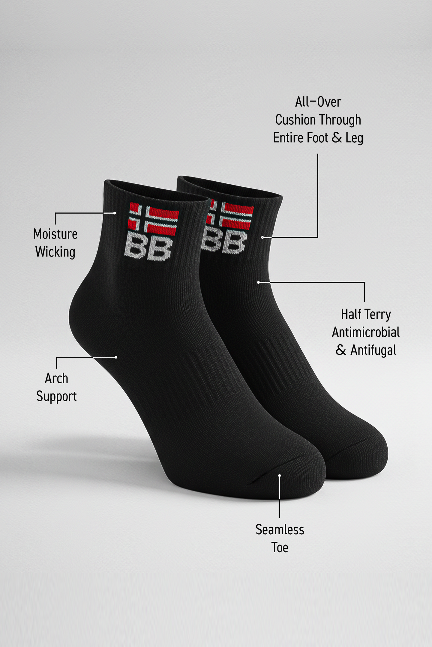 Two black BODYBORN crew-length socks displayed upright with embroidered BB logo and red-white flag, labeled with features including moisture-wicking material, arch support, half-terry antimicrobial and antifungal construction, all-over cushioning through the foot and leg, and seamless toe