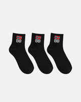 Three black crew-length socks arranged in a row on a white background, each displaying ribbed fabric and a BB logo embroidered beneath a red and white flag symbol