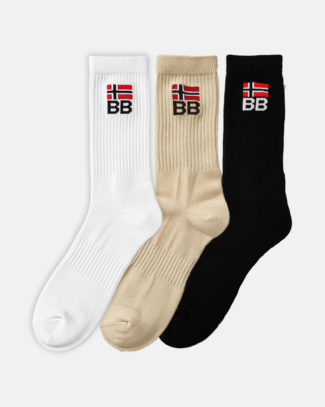 Set of three crew-length socks in white, beige and black, displayed side by side, each with ribbed knit and an embroidered BB flag logo at the top